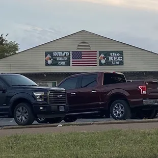 trucks parked in front of the building