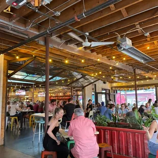 a large group of people sitting at tables in a restaurant