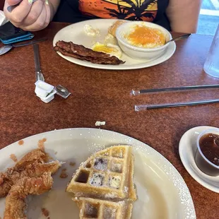 Chicken and waffle and eggs bacon and grits