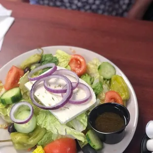 a plate of salad with dressing