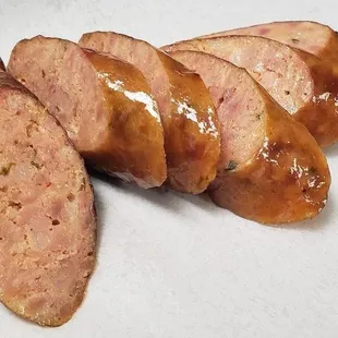 sliced sausage on a white plate