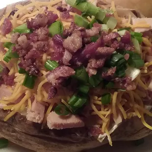Big Ol' Potato - stuffed with butter, sour cream, cheese, bacon, chives and your choice of meat.