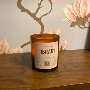 a candle sitting on a wooden table