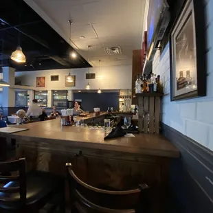 a view of a bar with people sitting at it