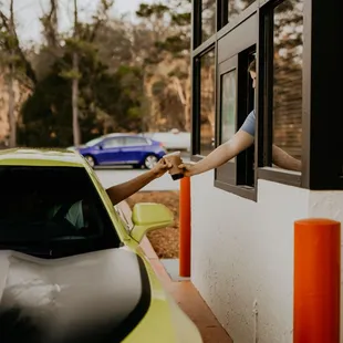 a woman reaching out of a window
