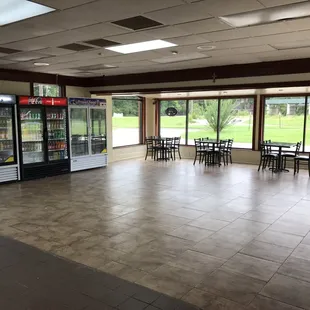 the inside of a restaurant with tables and chairs