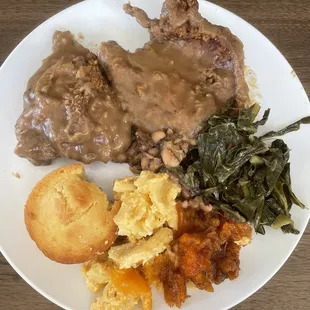 Smothered fried chicken, pork chop, Mac n cheese, yams and collard greens