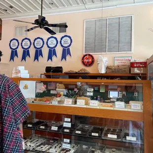 a woman standing in front of a display case
