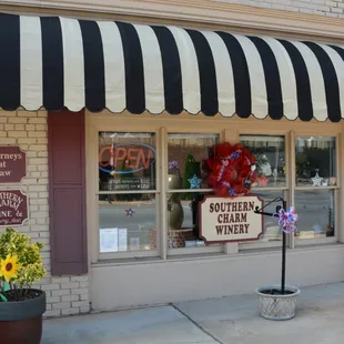 a storefront with a black and white awning