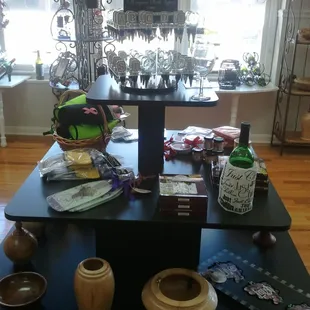 a display of wine glasses, vases, and other items
