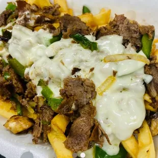 a plate of fries with meat and cheese