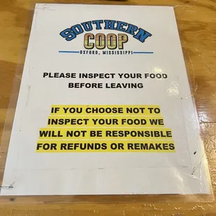 a sign on a wooden table