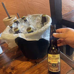a person holding a bottle of beer