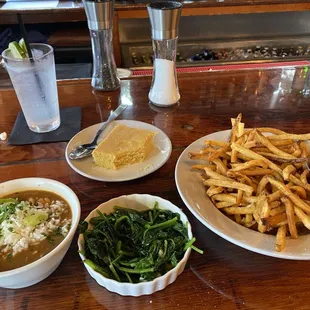 Gumbo, sautéed spinach, fries and corn bread.