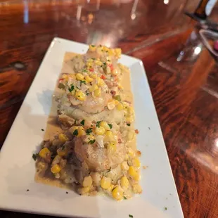 Scallops with corn on a bed of mashed potatoes