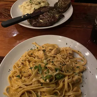 Creole fettuccine Alfredo with blackened chicken and a 14 oz ribeye with mashed potatoes.