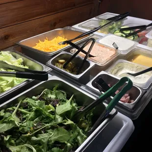 Fresh salad bar with your choice of iceberg or spring mix lettuce
