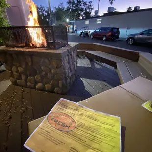 Outdoor, patio/deck under the oaks with a roaring fire