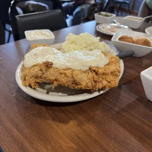 Chicken fried steak, pan seared pork, hush puppies with tangy orange butter, turnip greens and white beans AND peach cobbler cake!!!