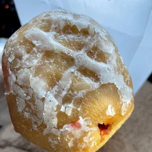 a hand holding a doughnut