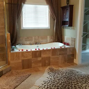 2 person jacuzzi with candles and rose petals
