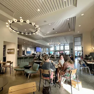 people sitting at tables in a restaurant