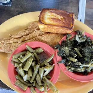 Fried catfish, cornbread, green beans, and greens.