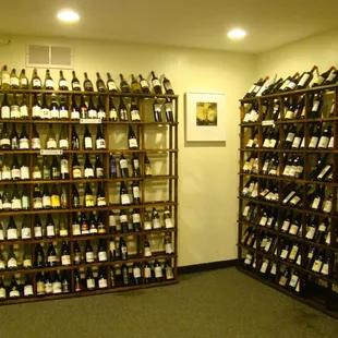 a man looking at bottles of wine