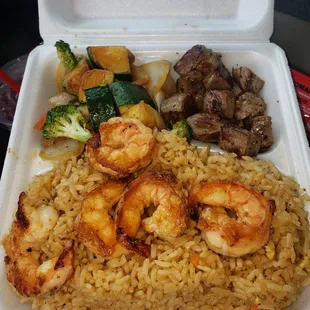 Steak and shrimp combination with fried rice and vegetables