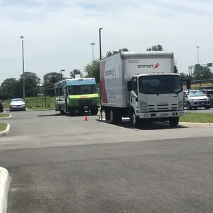 a truck and a bus in a parking lot