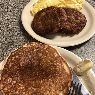 a plate of pancakes and scrambled eggs