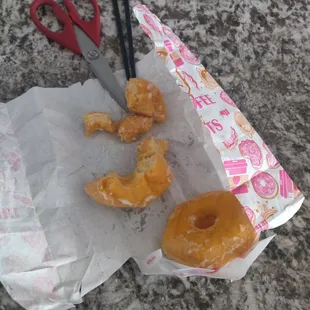 a bag of doughnuts and a pair of scissors