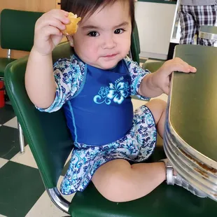 a toddler sitting at a table