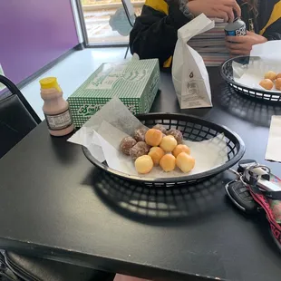Donut holes and half glazed, half chocolate covered to go!! Best donuts around