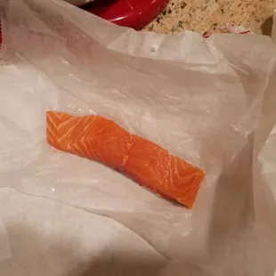 The employee's attempt at cutting a 1lb salmon filet in 'half'.  Total weight just over 0.2 lbs.