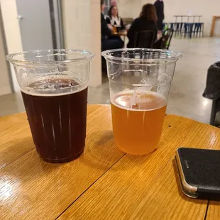 two glasses of beer and a cell phone