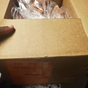 a person holding a box of donuts