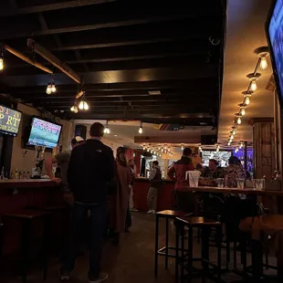 people at a bar watching tv