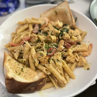 Rasta Pasta with sausage, shrimp, and chicken. And 2 pieces of toast.