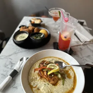 a bowl of grits with shrimp