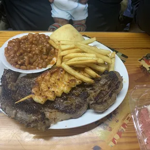 My hubby's ribeye dinner with an added shrimp skewer