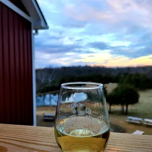 a glass of wine on a wooden table