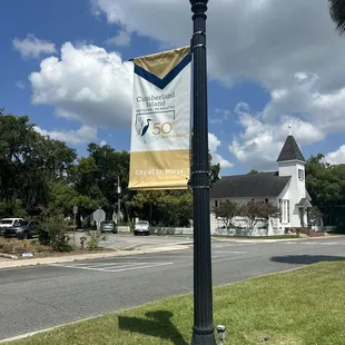 a lamp post with a banner on it