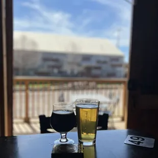 two glasses of beer on a table