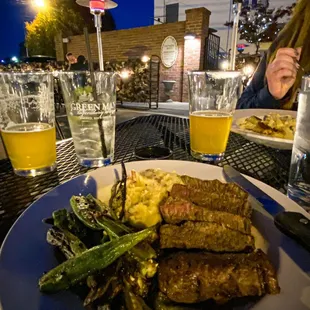 a plate of food and a glass of beer
