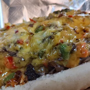 Our House roasted roast beef with grilled onions, green peppers and mushrooms topped with a heaping amount of homemade spicy pimiento cheese