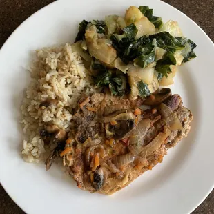 a plate of rice, meat, and vegetables