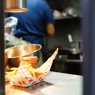 Chef Orlando serving fresh-hot and tasty french fries.