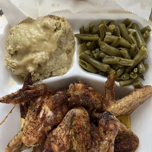Baked chicken wings.  Green beans.  Dressing with gravy.