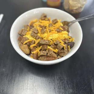 a bowl of cereal with cheese on top